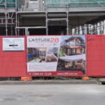 Red Shadecloth and Fence Panel Insert combining signage products to maximise site presence and cost savings